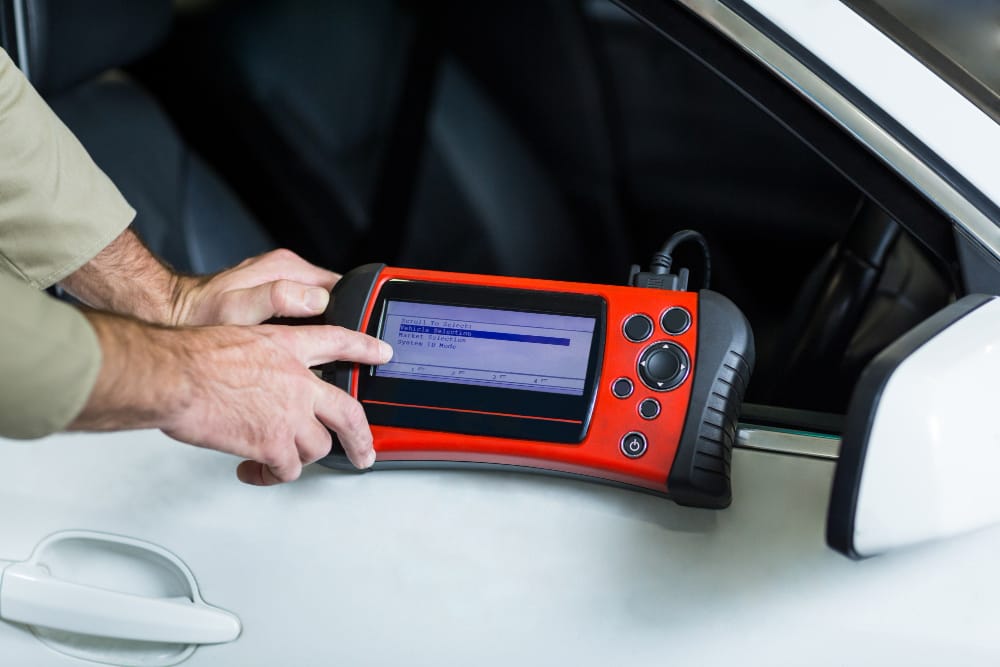 hands mechanic using diagnostic tool 1